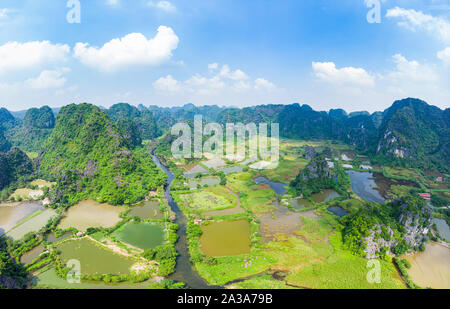 Luftaufnahme von Ninh Binh region, Trang Ein Tam Coc touristische Attraktion, UNESCO-Weltkulturerbe, malerischen Fluss Crawlen durch karst Bergketten Stockfoto