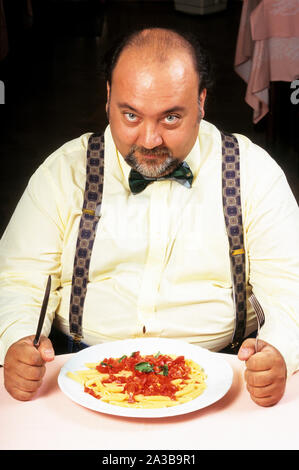 Fat man essen Pasta Stockfoto