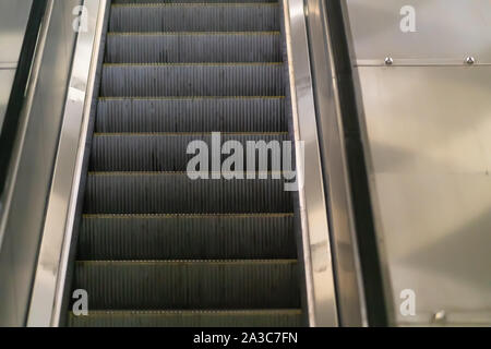 Schließen bis auf den Laufflächen eines leeren Fahrtreppe in einer U-Bahn oder Mall mit Reflexion auf den Stahl Seiten Stockfoto