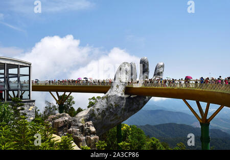 Danang, Vietnam - April 6, 2019: Die Goldene Brücke ist von zwei riesigen Händen in der Ferienanlage auf Ba Na Hill in Danang, Vietnam aufgehoben. Ba Na Hill Mou Stockfoto