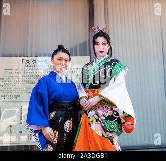 Tokyo, Japan - 30. Oktober 2018: Zwei junge Frauen in der traditionellen japanischen Kleidung auf einem Bürgersteig in Tokio, Japan. Stockfoto