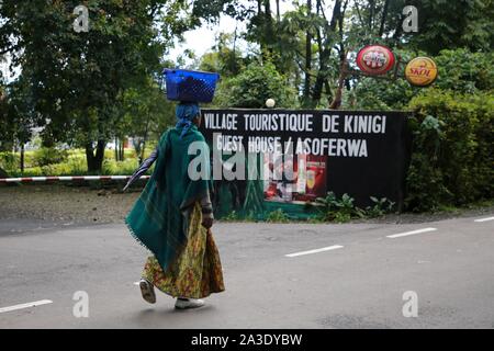 Kinigi, Ruanda. 7 Okt, 2019. Eine Frau an der Wegweiser für ein Gästehaus in Kinigi Sektor der Musanze District, nördlichen Ruanda, am 7. Oktober, 2019. Ruandische Polizei sagte, die Situation nach einem tödlichen Angriff in Kinigi Sektor, Tor zum Volcanoes National Park normalisiert wurde. Eine Gruppe von unbekannten Tätern mit Rohöl Waffen wie Messer und pangas und Gewehren ausgerüstet überfallen ein Dorf in Kinigi Sektor am Okt. 4, wobei mindestens 14 Menschen tot. Credit: Lyu Tianran/Xinhua/Alamy leben Nachrichten Stockfoto