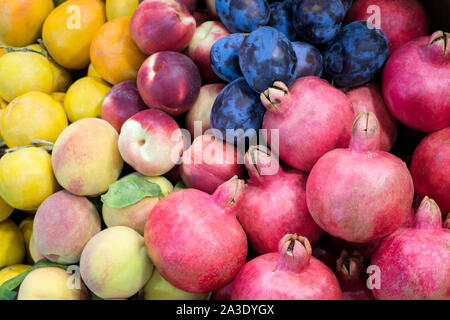 Granatapfel, Pflaumen, Nektarinen, Bündel, Pfirsich in einer Vitrine in einem Supermarkt. Stockfoto