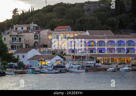 Nächtliche Abend lowlight Szene rund um den Hafen und das Meer in der Griechischen Ferienort Kassiopi auf der Insel Korfu in Griechenland mit Booten Stockfoto