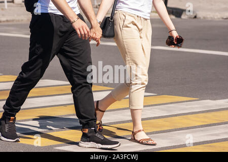 Beine der jungen Fußgänger auf dem Zebrastreifen in der Stadt im Sommer Tag Stockfoto