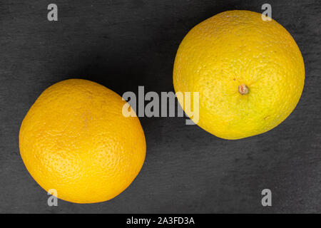 Gruppe von zwei ganze frische helle orange flatlay am grauen Stein Stockfoto