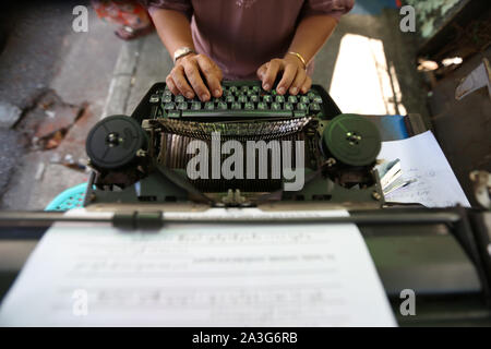 Yangon, Myanmar. 1. Okt, 2019. Eine Schreibkraft Arten heraus einen gesetzlichen Vertrag in Yangon, Myanmar, Oktober 1, 2019. Clickety-klack Geräusche von Schreibmaschinen kommen entlang einer belebten Straße in der Innenstadt von Myanmar Yangon gehört, Vibraphon wieder aus längst vergangenen Goldenen Zeitalter der Schreibmaschinen. Credit: U Aung/Xinhua/Alamy leben Nachrichten Stockfoto