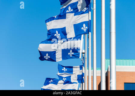 Québec Fahnen schwenkten im Wind gegen den blauen Himmel in Quebec City. Stockfoto