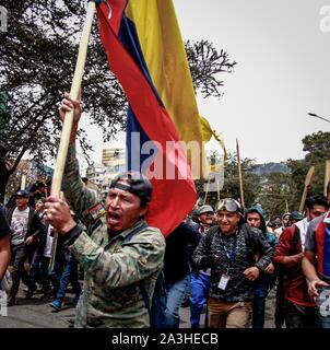 Quito, Ecuador. 08 Okt, 2019. Ein Demonstrator schreien politische Parolen und Fliegen einer ecuadorianischen Flagge aus Protest gegen die Wirtschaftspolitik der Regierung von Präsident Moreno. Die Konföderation der indigenen Völker (Conaie) hat für einen großen Marsch nach Quito genannt. Der ecuadorianischen Hauptstadt erwartet rund 20.000 Demonstranten der indigenen Völker gegen die Preiserhöhungen und die Erdölförderung in ihren Territorien am Dienstag protestieren zu bewirten. Die Regierung den Notstand und bewegt von der Hauptstadt nach Guayaquil. Credit: Juan Diego Montenegro/dpa/Alamy leben Nachrichten Stockfoto