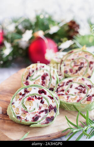 Frische hausgemachte Cranberry pinwheels mit Frischkäse, getrocknete Cranberries, Walnüsse, Ziegenkäse und Rosmarin für die Feiertage bereit. Selektive foc Stockfoto