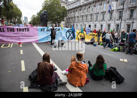 London, Großbritannien. 08 Okt, 2019. Aktivisten blockieren Whitehall während der Umweltschutz Protest vom Aussterben Rebellion Aktivist Gruppe. Aussterben Rebellion ist eine internationale Bewegung, die nicht nutzt, gewaltfreien zivilen Ungehorsam in einem Versuch, Massensterben zu stoppen und die Gefahr der sozialen Kollaps. Die Gruppe hat eine Reihe von wichtigen Kreuzungen in Central London blockiert. Credit: SOPA Images Limited/Alamy leben Nachrichten Stockfoto