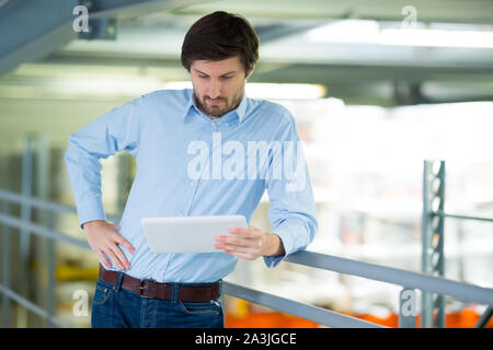 Junge Unternehmer arbeiten mit Tablet in der Factory Stockfoto