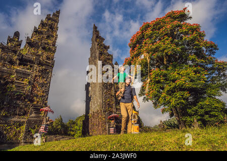 Vater und Sohn gehen durch traditionelle balinesische Hindu tor Candi Bentar in der Nähe von Bedugul, Bratan See Insel Bali Indonesien. Urlaub auf Bali Stockfoto