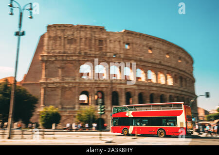 Rom, Italien. Kolosseum. Rote Hop on-Hop off-Touristische Bus für Sightseeing in der Straße in der Nähe der Flavischen Amphitheater. Berühmte UNESCO-Wahrzeichen. Stadt Anblick Stockfoto