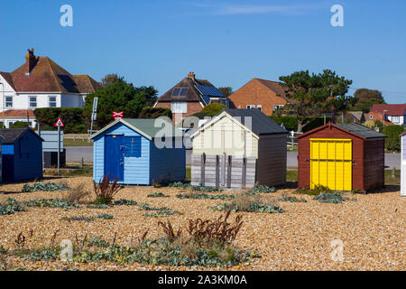 19. September 2019 Traditionelle Familie Strandhütten flankiert Meine wilden Strand Pflanzen in Hayling Island Beach an der Südküste von England Stockfoto