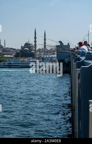 Istanbul: Skyline der Stadt und die lokalen Fischer mit ihren Angel auf der Galata Brücke, die Brücke über das Goldene Horn und den Bosporus. Stockfoto