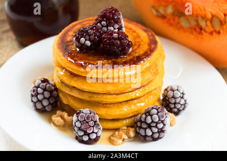Kürbis Pfannkuchen mit Ahornsirup, Beeren und Nüsse. Am Ende der Saison (Herbst) Frühstück. Stockfoto