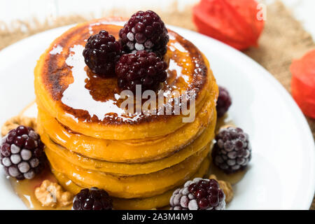 Kürbis Pfannkuchen mit Ahornsirup, Beeren und Nüsse. Am Ende der Saison (Herbst) Frühstück. Stockfoto