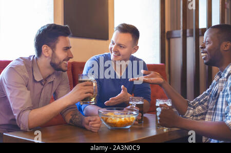 Aufgeregt, Freunde, interessante Diskussion, während Sie in der Bar sitzen Stockfoto