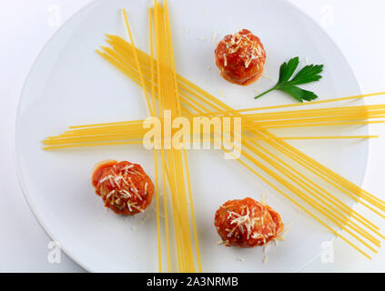 Italienische Küche. Spaghetti mit Fleischbällchen, Pasta mit Tomatensauce und geriebenem Parmesan auf weißem Hintergrund. Ansicht von oben Stockfoto
