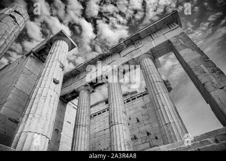 Von hinten beleuchtete von Sun und körnige Parthenon Spalten gen Himmel erreichen in Richtung Wolken in Schwarzweiß. Stockfoto