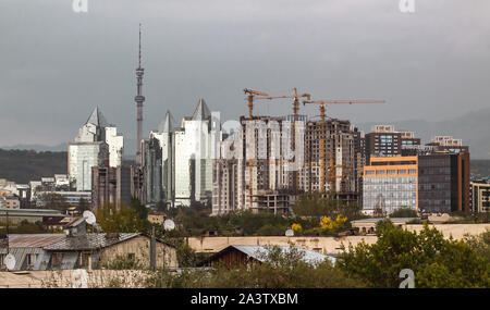 ALMATY, Kasachstan - 14. MAI 2017: Nurly Tau Business Center in Wetter auf dem Hintergrund der Baukräne. Stockfoto