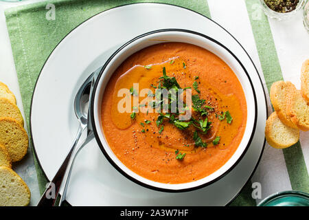 Cremesuppe von roten Linsen mit Tomaten auf dem Tisch. gesund vegan Erwärmung Essen für die ganze Familie. Stockfoto