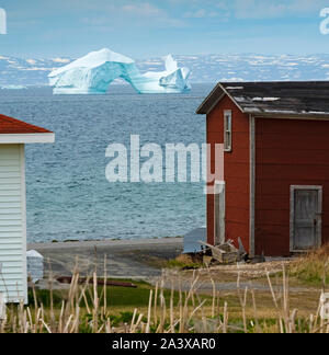 Eisberg auf der Grünen Insel Bucht mit Red Barn im Vordergrund, Neufundland Stockfoto