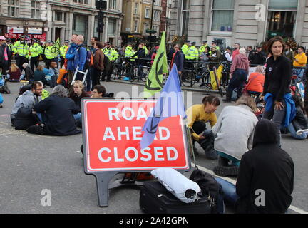 London, Großbritannien. 10 Okt, 2019. Die Demonstranten sitzen auf dem Boden und blockieren die Straße während der Demonstration. Aussterben Rebellion Demonstranten protestieren am Trafalgar Square und Whitehall der 'Klima Notfall" mit Blick auf die Planeten zu markieren. Credit: SOPA Images Limited/Alamy leben Nachrichten Stockfoto