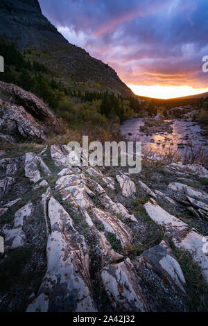 Landschaft einer Felsformation direkt neben Swiftcurrent alke mit den Sonnenaufgang auf dem Hintergrund, Montana. Stockfoto