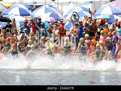 Schwimmer in Scharen in das Meer in 2019 Lanzhou Internationale Open Water Swimming Herausforderung in Lanzhou Stadt teilzunehmen, East China ¯ s Jiangsu p Stockfoto