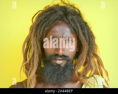Scruffy untere Kaste der tamilischen Bettler mit Dreadlocks und schwarzen Bart posiert für die Kamera. Stockfoto