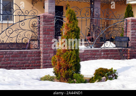 Viel Schnee liegt auf einem Wohngebäude und große Schneeverwehungen um. Jahreszeiten. Stockfoto