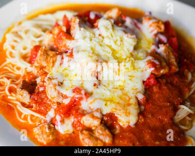 Pasta mit Fleisch und Tomaten auf einer weißen Platte Stockfoto