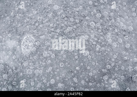 In der Nähe des gefrorenen Luftblasen im Eis im Winter von oben gesehen. Abstract full frame Hintergrund in Schwarz und Weiß. Kopieren Sie Platz. Stockfoto