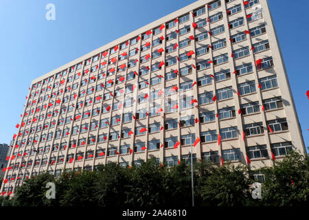Chinesischen Nationalen Fahnen flattern auf der Windows auf dem Campus der Liaoning Universität der Traditionellen Chinesischen Medizin der bevorstehenden Nationalen Tag, an dem ich zu markieren Stockfoto