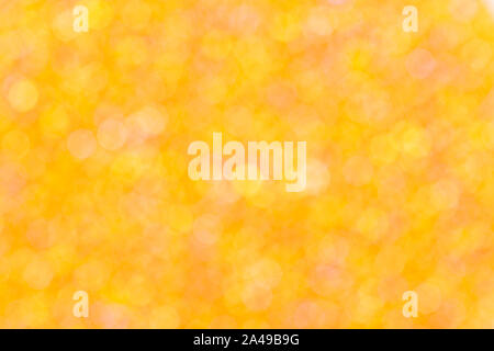 Gelb und Orange bokeh auf dem orangen Hintergrund. Stockfoto