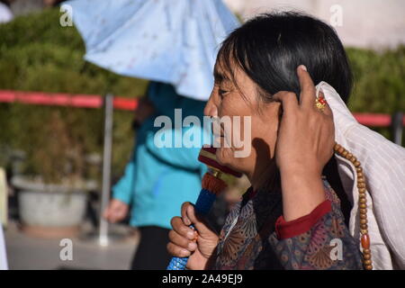 Alte tibetische Frau in traditioneller Kleidung in der Nähe Jokhang Tempel in Lhasa - Tibet Stockfoto