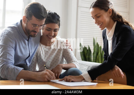 Glücklich verheiratet diverse Paar unterzeichnen Vertrag, wodurch rechtliche Abkommen Stockfoto
