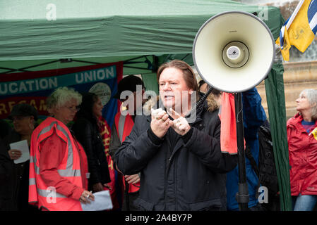 Trafalgar Square, London, UK. 12. Oktober 2019. Aussterben Rebellion gefragt, Gewerkschaften ihre Rebellion auf dem Trafalgar Square. Eine Gewerkschaftliche Präsenz aktiv war, mit Lautsprecher, und Sie später ein XR März verbunden. Bild sprechen, Bäcker, Lebensmittel- und Allied Workers Union (BFAWU) Präsident Ian Hodson. Lautsprecher, TU und XR Unterstützer braved Dauerregen. Credit: Stephen Bell/Alamy Stockfoto