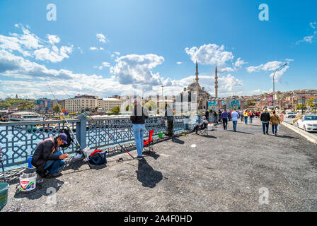 Lokale türkische Fischer ihre Angeln aus dem Bosporus Brücke, mit dem Stadtteil Sultanahmet und Suleymaniye Moschee in der Ferne. Stockfoto