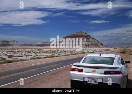 Arizona, USA, landschaftlich reizvolle Ansicht der Chinle Formation, einem Berg gestapelter Schichten durch die Zeit mit dem Chevrolet Camaro Auto in der Wüste, Route 66 2015 Stockfoto