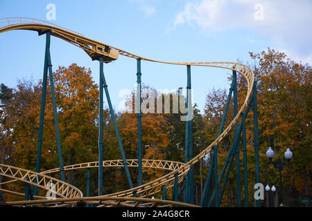 Close up moderner Kühle Achterbahnfahrt gegen Vergnügungspark, blauer Himmel und weiße Wolken, Spaß Festival Stockfoto