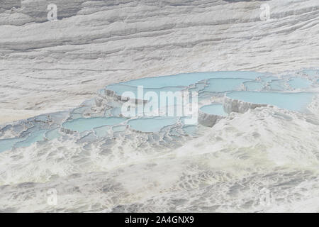 Pamukkale in der Türkei ist bekannt für seine mineral-reiche Thermalwasser nach unten fließenden weißen Travertin Terrassen. Pamukkale ist unter dem Spitznamen Baumwolle schloss. Stockfoto