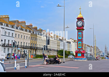 Die Jubilee Clock Tower auf der Esplanade zum Gedenken an das Goldene Jubiläum der Königin Victoria 1888. Grad II aufgeführt. Reihe von hübschen Reihenhäusern. Stockfoto