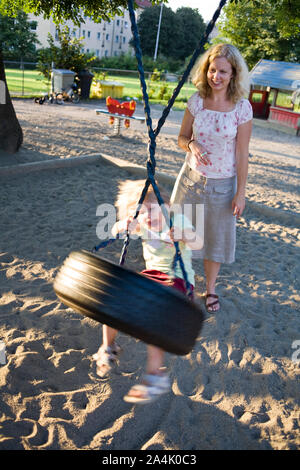 Kinder spielen mit Swing Stockfoto