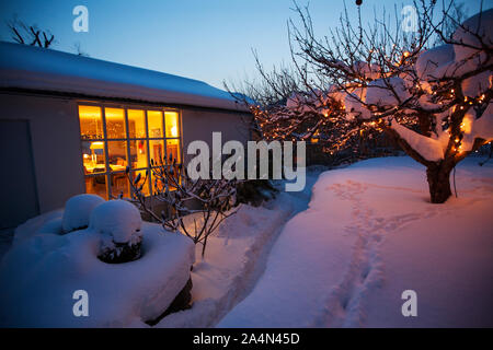 Blick auf das beleuchtete Haus im Winter Stockfoto