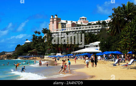 St. Thomas, Virgin Islands - 18, Februar 2015: Touristen genießen einen schönen Tag am Strand in St. Thomas Virgin Islands mit Hotel auf einem Hügel über. Stockfoto