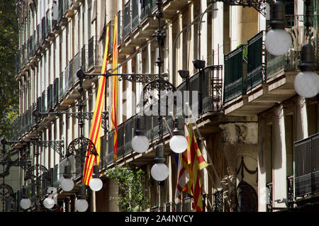 Die senyera Flagge hängen von den Gebäuden auf einer Straße in Barcelona, Spanien Stockfoto