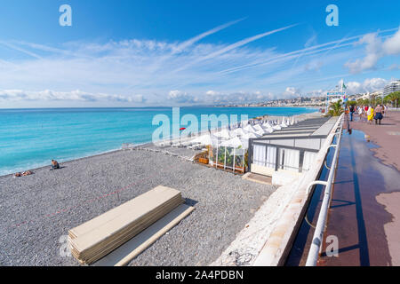 Einen privaten Beach Club mit weißen Sonnenschirmen und Liegestühlen am Strand an der französischen Riviera in Nizza Frankreich Stockfoto